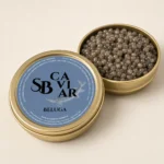 Open Beluga caviar tin showing large dark grey pearls