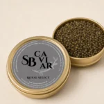 Open Royal Select caviar tin showing dark glossy pearls