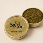 Open Imperial Gold caviar tin showing golden amber pearls